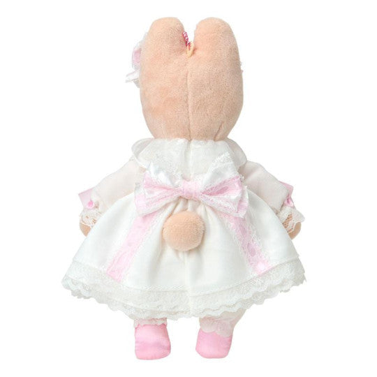 Plush toy rabbit in a white dress with pink accents on a white background